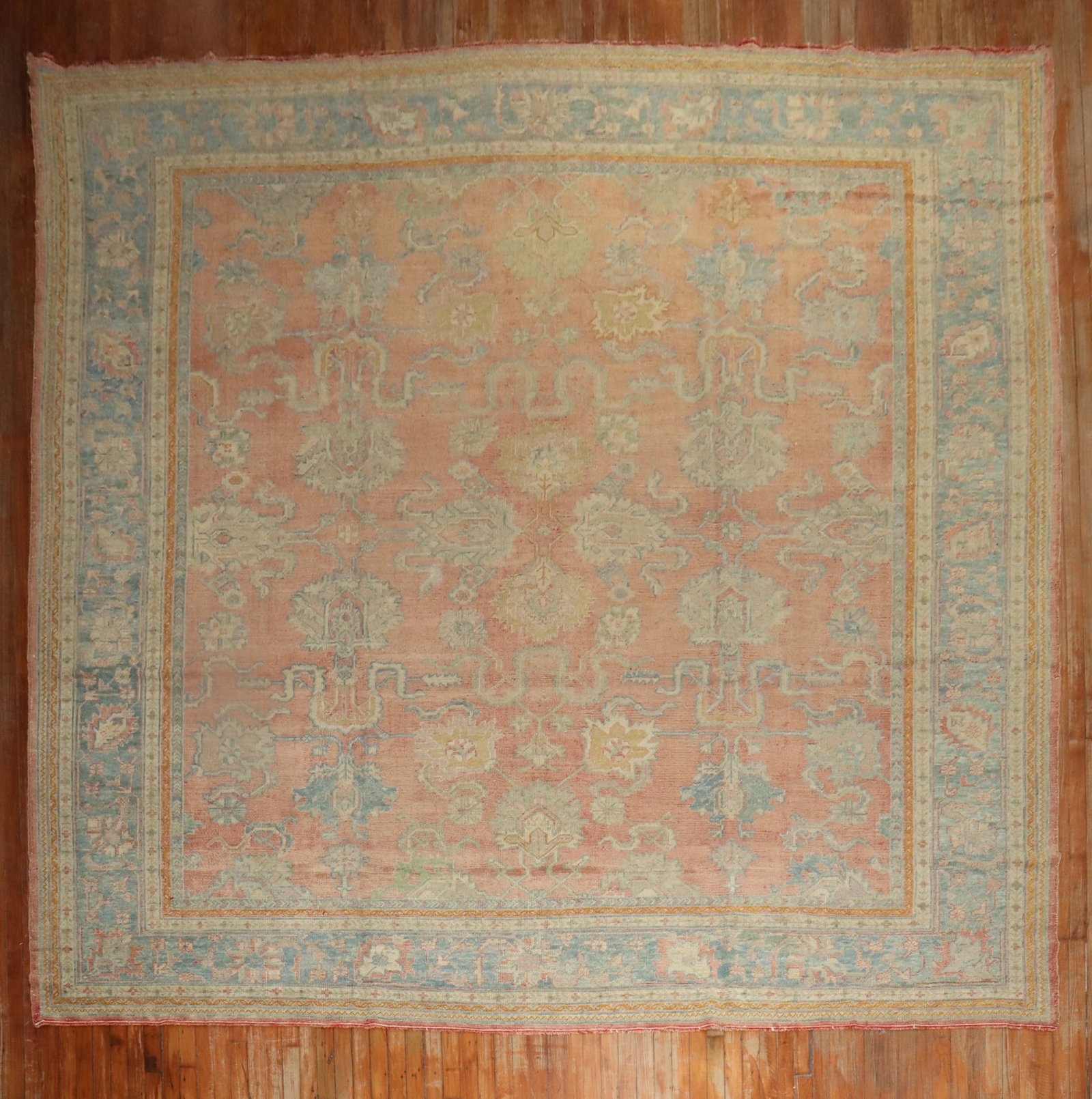 11' 6" x 13' Turkish Oushak room rug square 1920s: 11' 6" x 13' Turkish Oushak room rug square 1920s Antique Turkish square Oushak rug from the 1920s featuring a soft orange field and a light blue border. This pre-owned room-size rug showcases the cla