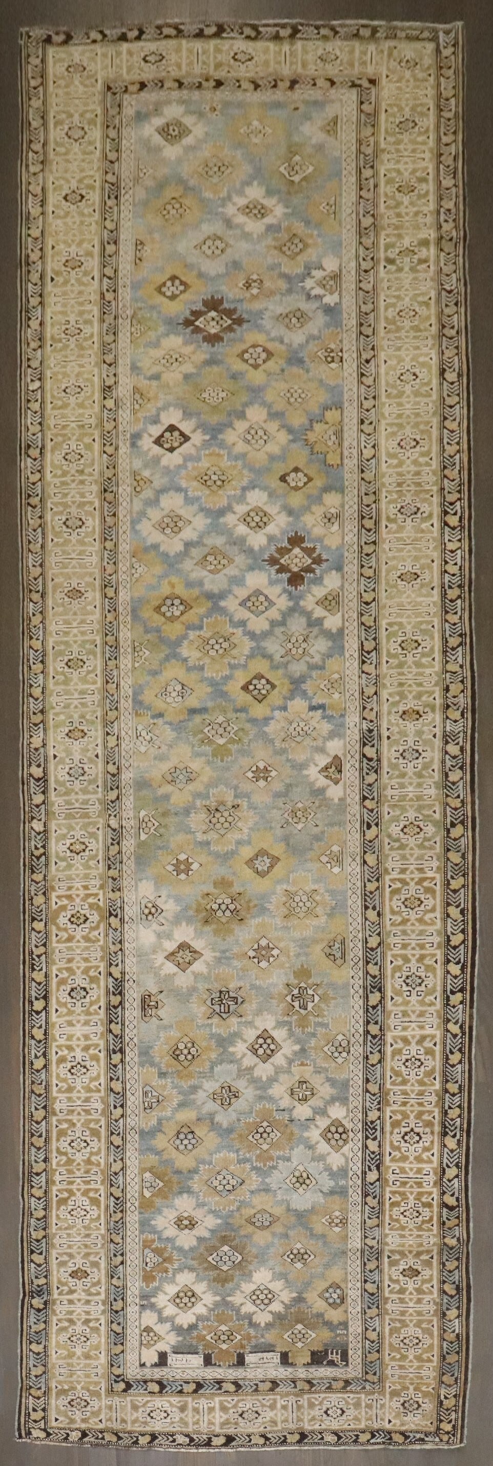 1906 Dated Kuba Caucasian Runner Rug 3' 11" x 12' 5": 1906 Dated Kuba Caucasian Runner Rug 3' 11" x 12' 5" Antique Caucasian Kuba runner featuring a snowflake motif and a dated inscription interpreted as 1324 AH, corresponding roughly to 1906 AD. The whi