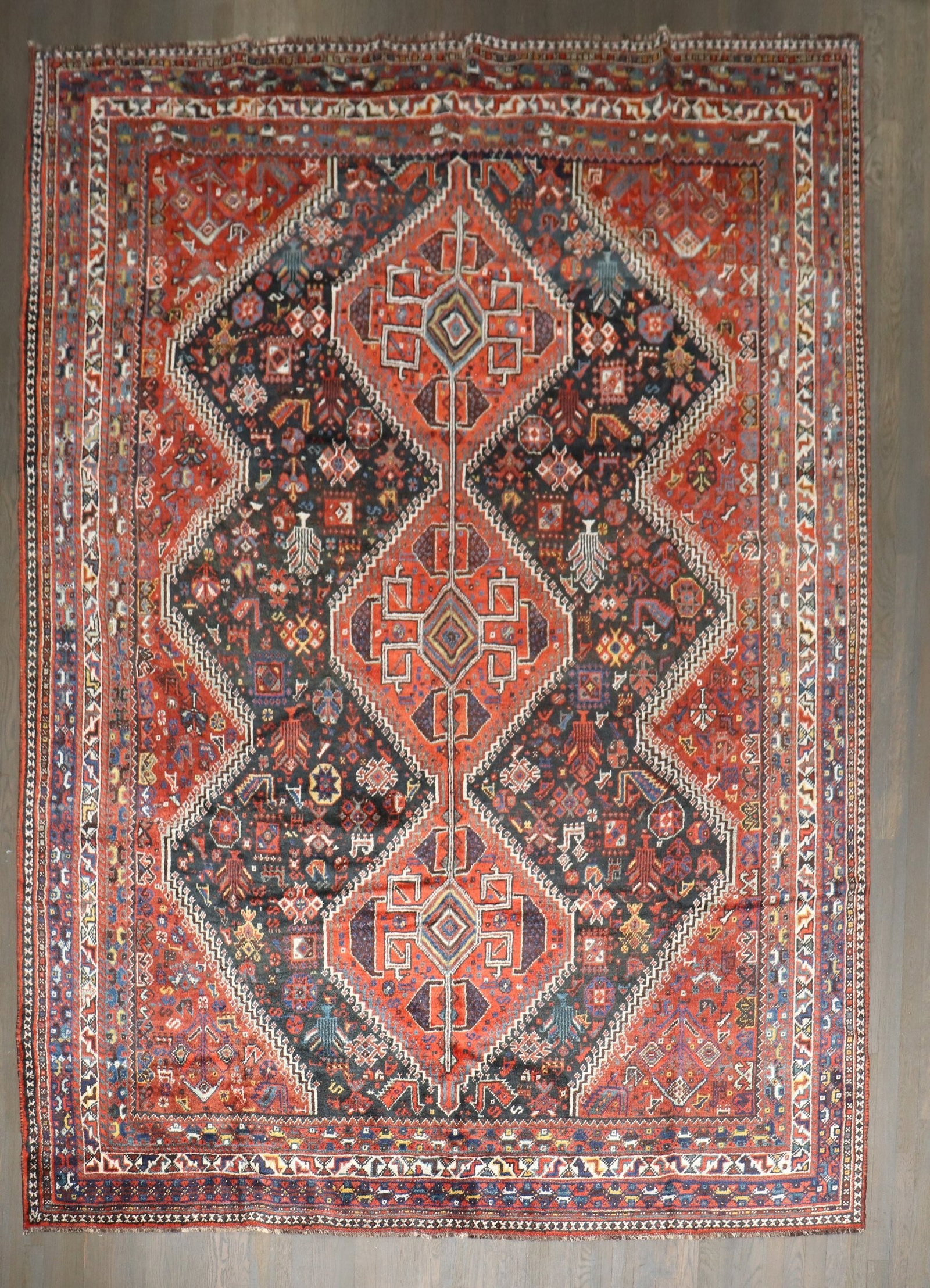 7' 7" x 10' 2" Geometric Persian Shiraz Room Rug: 7' 7" x 10' 2" Geometric Persian Shiraz Room Rug Early 20th-century Persian Shiraz rug featuring a geometric design in jewel-tone colors. This pre-owned room-size rug is identified as a Shiraz type. S