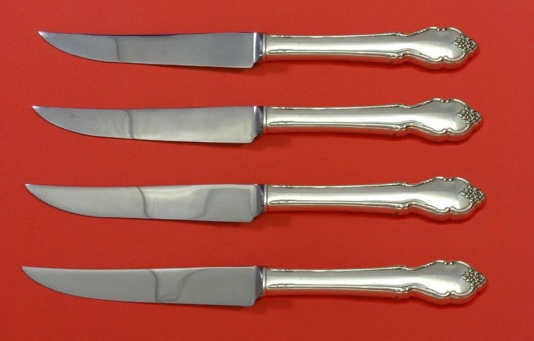 International Sterling Silver Breton Rose 4pc Steak Knife Set: International Sterling Silver Breton Rose 4pc Steak Knife Set Enhance your dining experience with this exquisite 4-piece steak knife set from the Breton Rose pattern by International. Crafted with a s