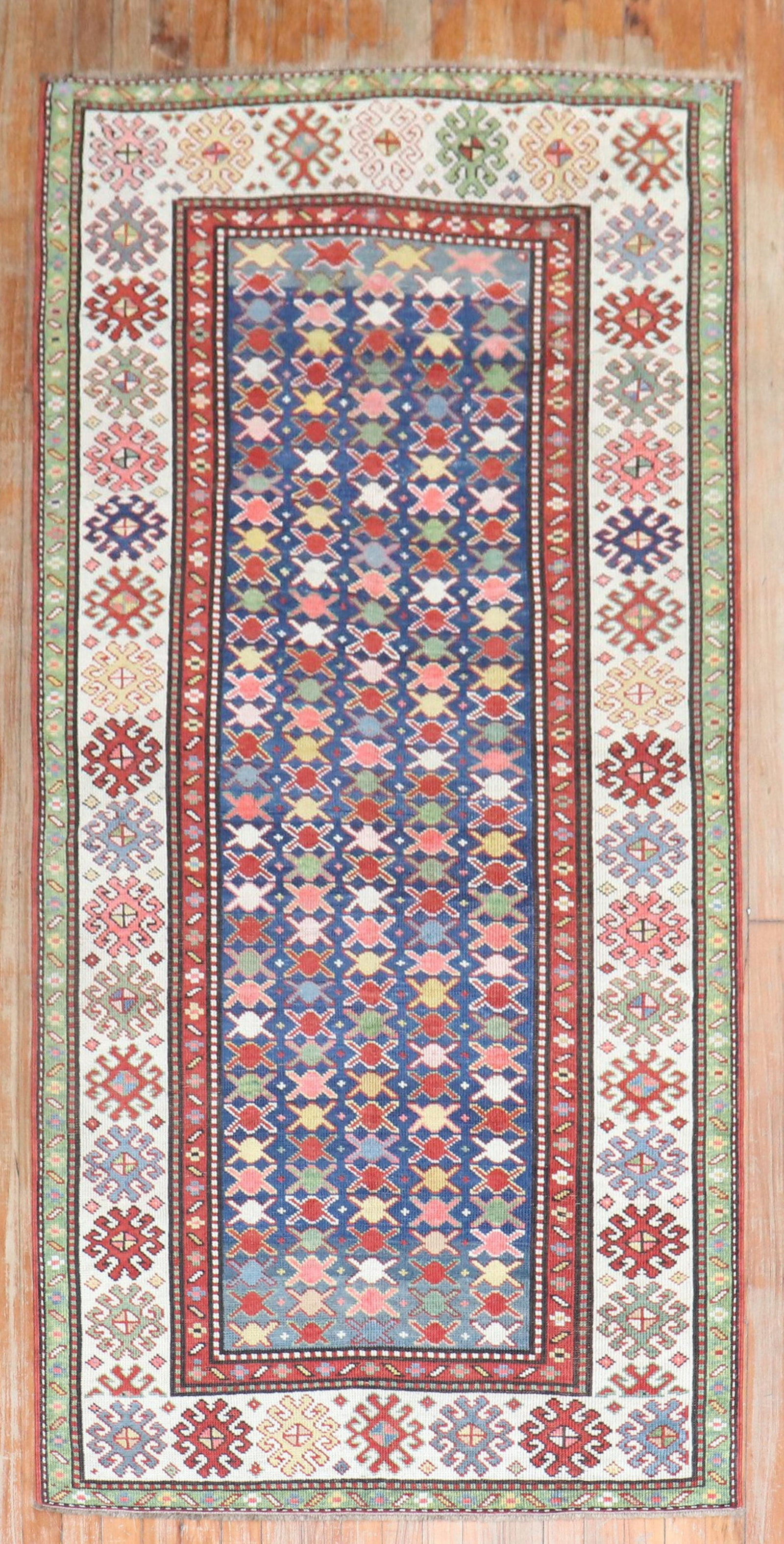 3' 4" x 7' 6" Early 20th Century Caucasian Kuba Runner: 3' 4" x 7' 6" Early 20th Century Caucasian Kuba Runner Early 20th century Caucasian Kuba runner featuring a colorful repetitive geometric design on a navy field. This pre-owned rug offers a decorative