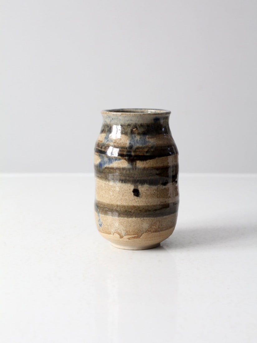 Handmade Vintage Studio Pottery Vase with Tan Glaze and Blue Accents: Handmade Vintage Studio Pottery Vase with Tan Glaze and Blue Accents This vintage studio pottery vase showcases a unique, handmade design by a skilled artist. It features a beautiful tan speckled glaz