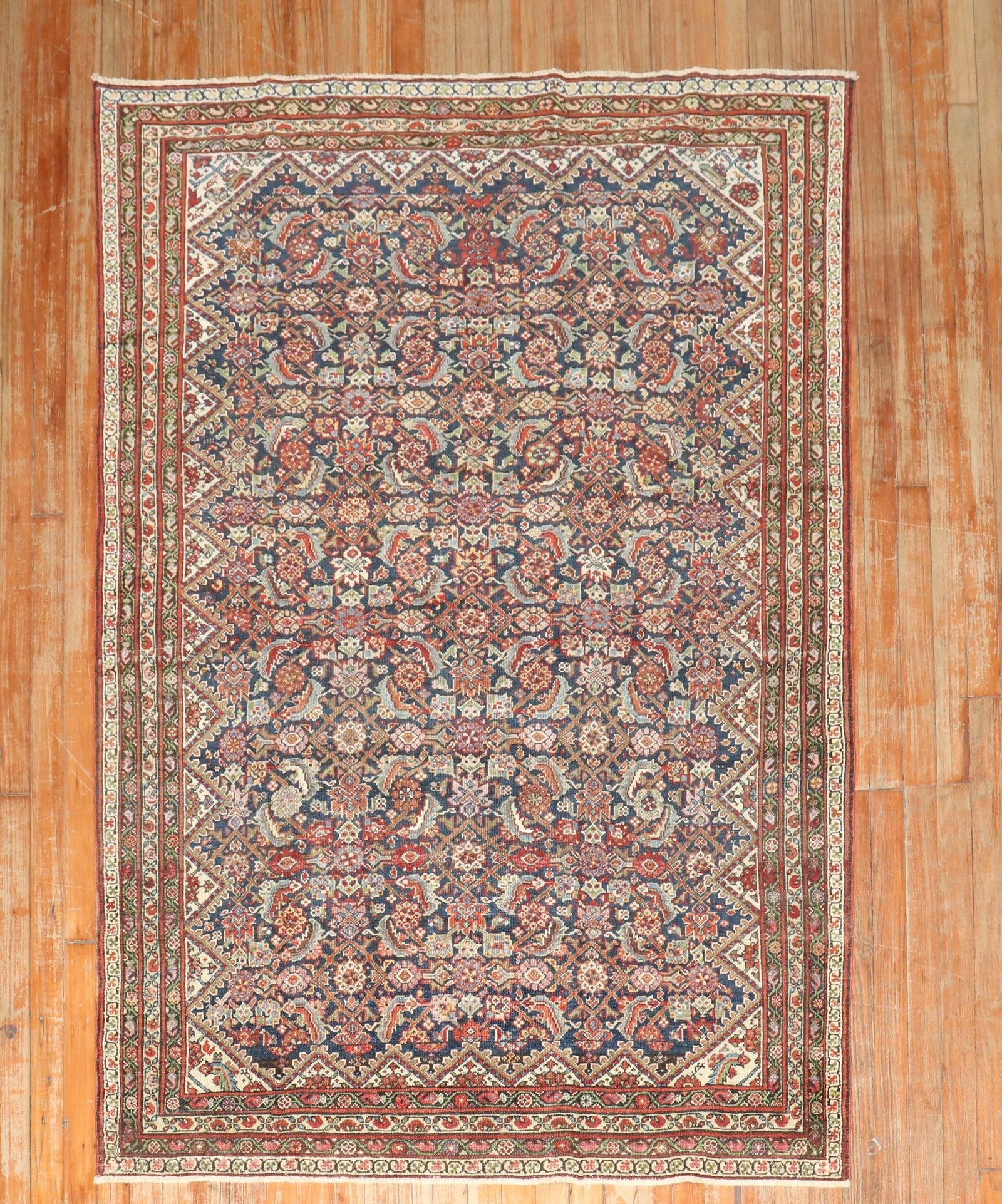 4' 4" x 6' 2" Persian Ferehan Accent Rug: 4' 4" x 6' 2" Persian Ferehan Accent Rug Pre-owned Persian Ferehan accent rug from the 1920s. The rug features a Herati-style design and is presented in a navy color palette. Specifications Type: Fere