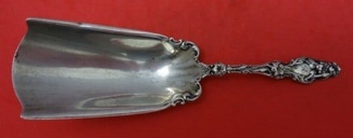 Whiting Lily Sterling Silver Serving Almond Scoop 5 7/8 in: Whiting Lily Sterling Silver Serving Almond Scoop 5 7/8 in Sterling silver almond scoop in the Lily pattern by Whiting. This serving piece is 5 7/8 inches long, is not monogrammed, and is in excellent