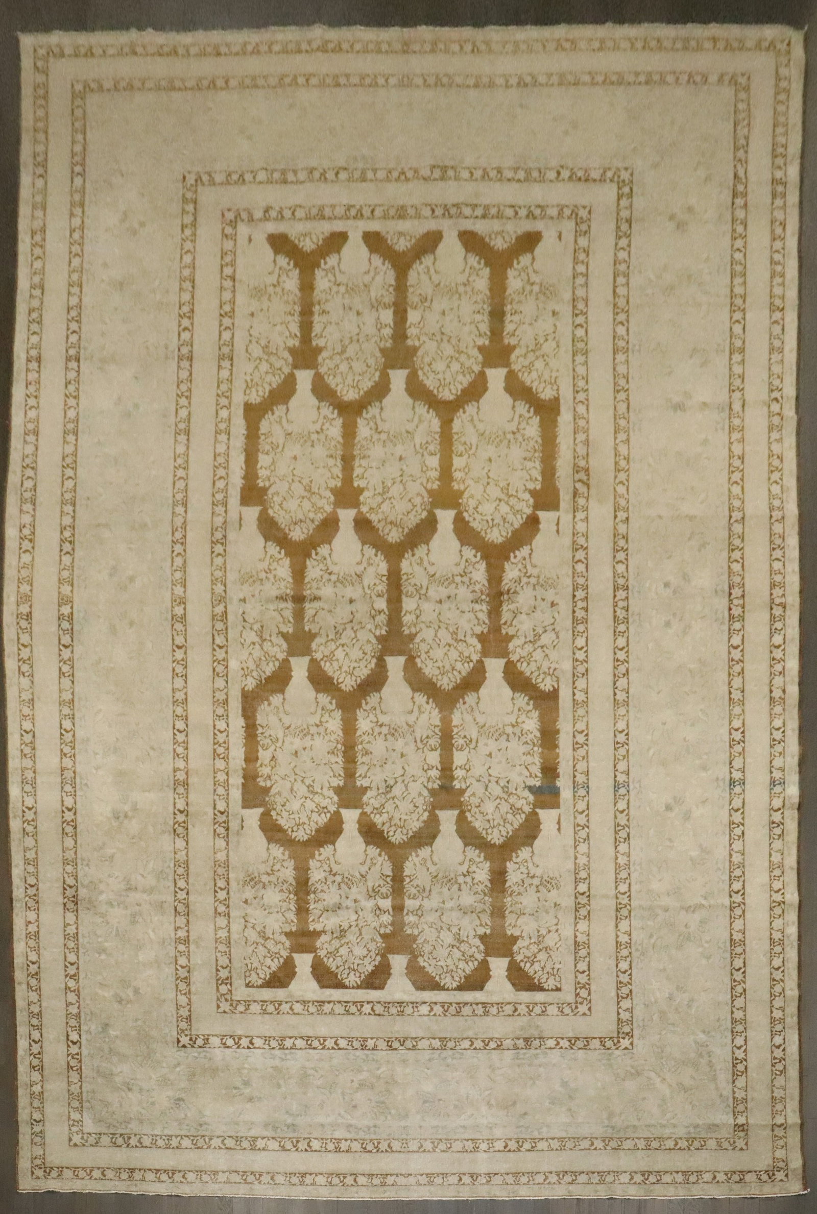 10' x 15' 7" Antique Indian Larestan Room Rug Plant Vase Pattern: 10' x 15' 7" Antique Indian Larestan Room Rug Plant Vase Pattern Early 20th century Indian Larestan rug featuring an all-over large-scale plant vase pattern on a brown field. This pre-owned room-size 