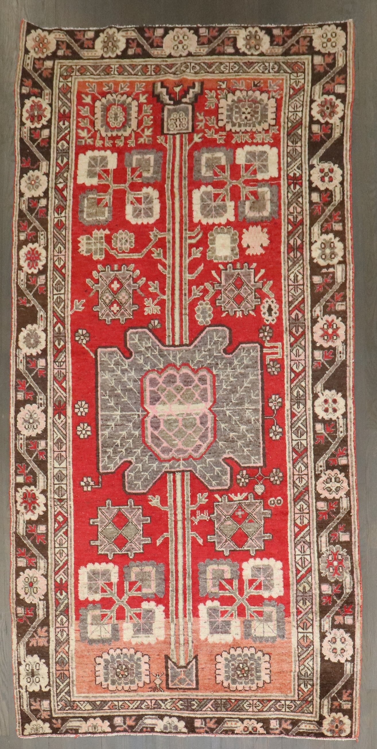 4' 8" x 9' 3" Early 20th Century Khotan Samarkand Rug: 4' 8" x 9' 3" Early 20th Century Khotan Samarkand Rug Early 20th century Red Samarkand Khotan rug with intricate geometric patterns and floral motifs. This pre-owned area rug is identified as a Khotan