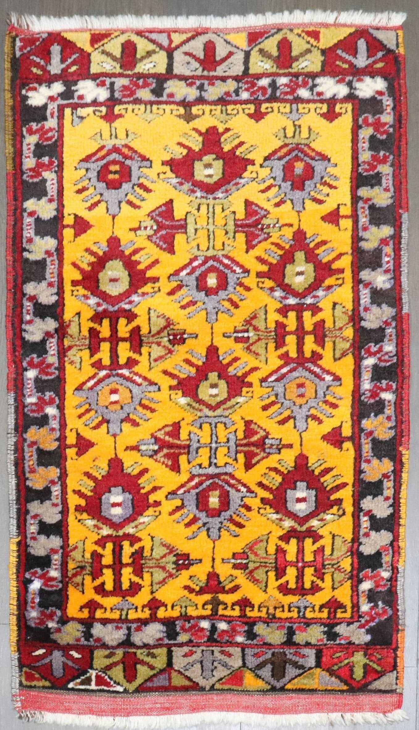 1' 8" x 3' Turkish Anatolian Yastik Rug Yellow Field: 1' 8" x 3' Turkish Anatolian Yastik Rug Yellow Field Antique Turkish Anatolian yastik rug with a yellow field, dating to the early 20th century. This pre-owned piece reflects the traditional character