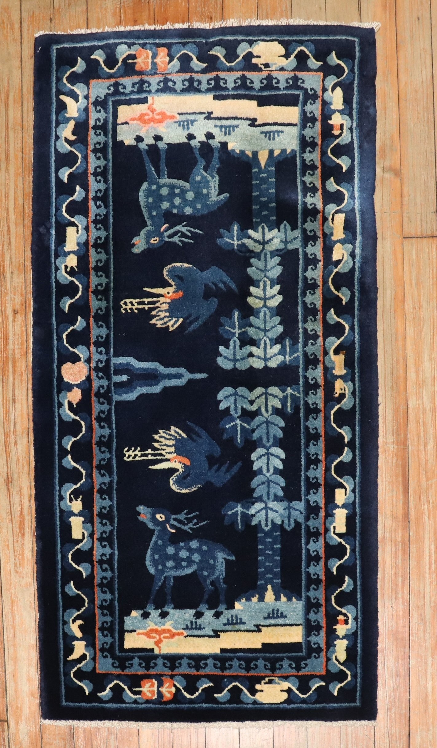 1' 11" x 3' 7" Chinese Peking pictorial yastik rug: 1' 11" x 3' 7" Chinese Peking pictorial yastik rug Mid 20th century Chinese Peking pictorial rug with a navy field and a stylized reindeer and bird motif. The design is framed by floral and geometric 