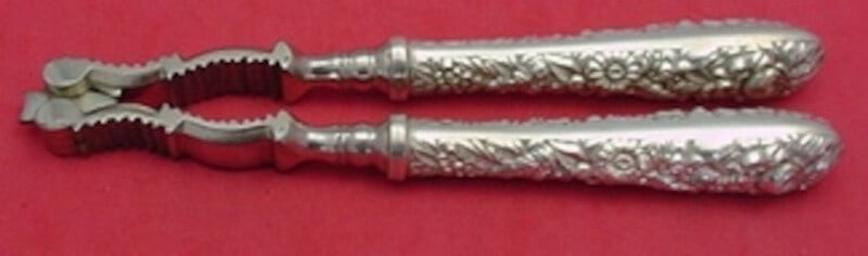 Kirk Sterling Silver Repousse Nut Cracker 6 7/8 Inch: Kirk Sterling Silver Repousse Nut Cracker 6 7/8 Inch This exquisite nutcracker by Kirk showcases a classic Repousse pattern, crafted from high-quality sterling silver. Measuring 6 7/8 inches, it featu