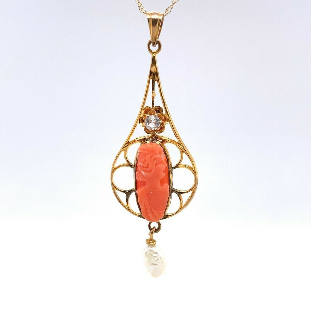 Victorian 10k Gold Coral Cameo Lavaliere With Pearl Drop: Victorian 10k Gold Coral Cameo Lavaliere With Pearl Drop This Victorian-era lavaliere pendant is crafted from 10k yellow gold and features an intricately carved coral cameo as its centerpiece. The ora