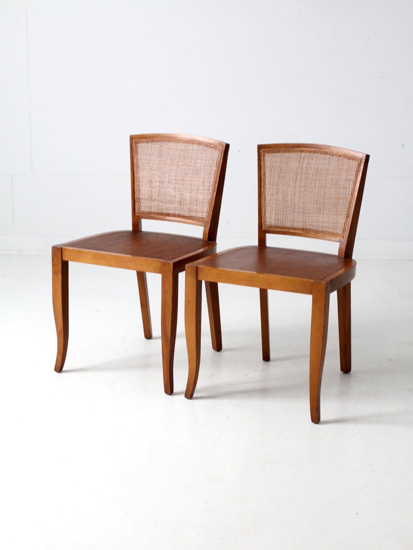 Mid Century Teak Cane Back Chairs Pair with Saber Legs: Mid Century Teak Cane Back Chairs Pair with Saber Legs This exquisite pair of mid-century cane back chairs showcases warm teak wood tones and gracefully curved saber legs. The finely woven caned backr