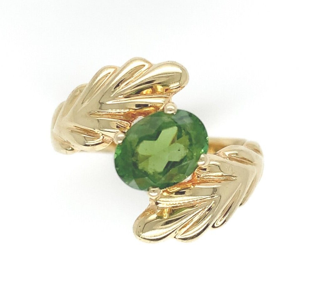 14k Yellow Gold Leaf Bypass Ring with Natural Peridot Size 6.25: 14k Yellow Gold Leaf Bypass Ring with Natural Peridot Size 6.25 This exquisite bypass ring features a genuine natural peridot gemstone, elegantly set in 14k yellow gold. The stunning oval peridot, mea
