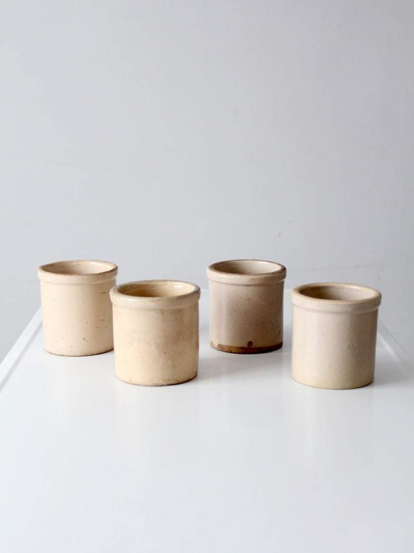Set of 4 Antique Stoneware Crock Collection: Set of 4 Antique Stoneware Crock Collection Set of four antique stoneware crocks with classic rounded forms and softly varied neutral tones. These crocks show age-appropriate wear, including surface w