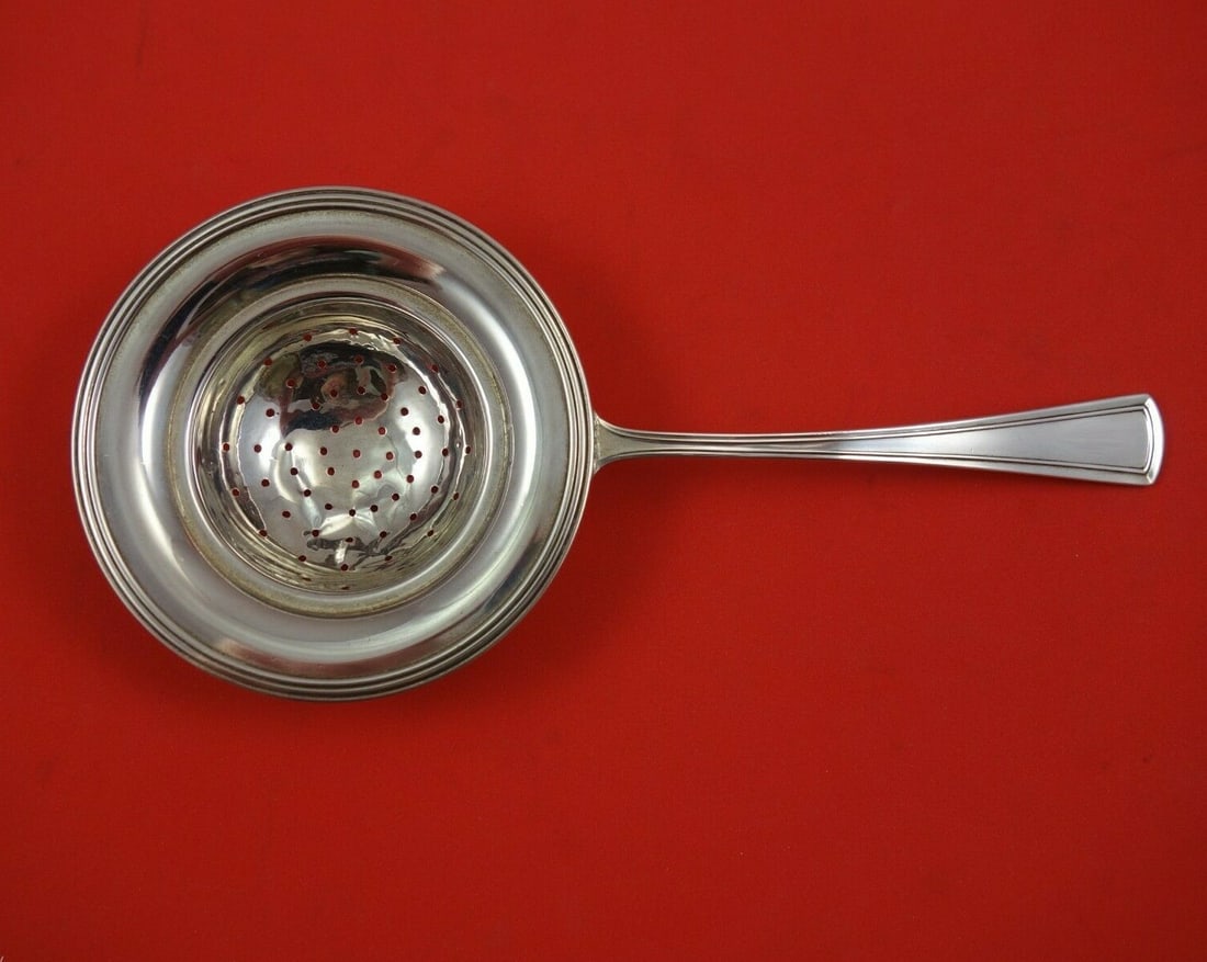 Dominick & Haff Virginia Sterling Silver Tea Strainer 7.5 Inch: Dominick & Haff Virginia Sterling Silver Tea Strainer 7.5 Inch This exquisite tea strainer, crafted by Dominick and Haff, showcases the elegant Virginia pattern. Measuring 7 1/2 inches, it is made of 