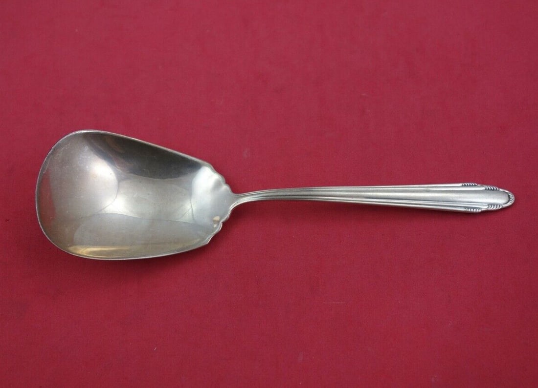Dominick & Haff Contempora Sterling Silver Preserve Spoon 7.5": Dominick & Haff Contempora Sterling Silver Preserve Spoon 7.5" This exquisite serving spoon is a sterling silver preserve spoon from the esteemed Contempora pattern by Dominick & Haff. Measuring 7 1/2