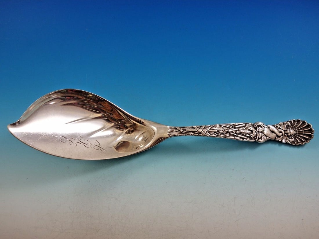 Tiffany & Co Dolphin Sterling Silver 12 Inch Ice Cream Server: Tiffany & Co Dolphin Sterling Silver 12 Inch Ice Cream Server Indulge in elegance with this exquisite 12" ice cream server from Tiffany & Co., crafted in fine sterling silver. The renowned Dolphin pat