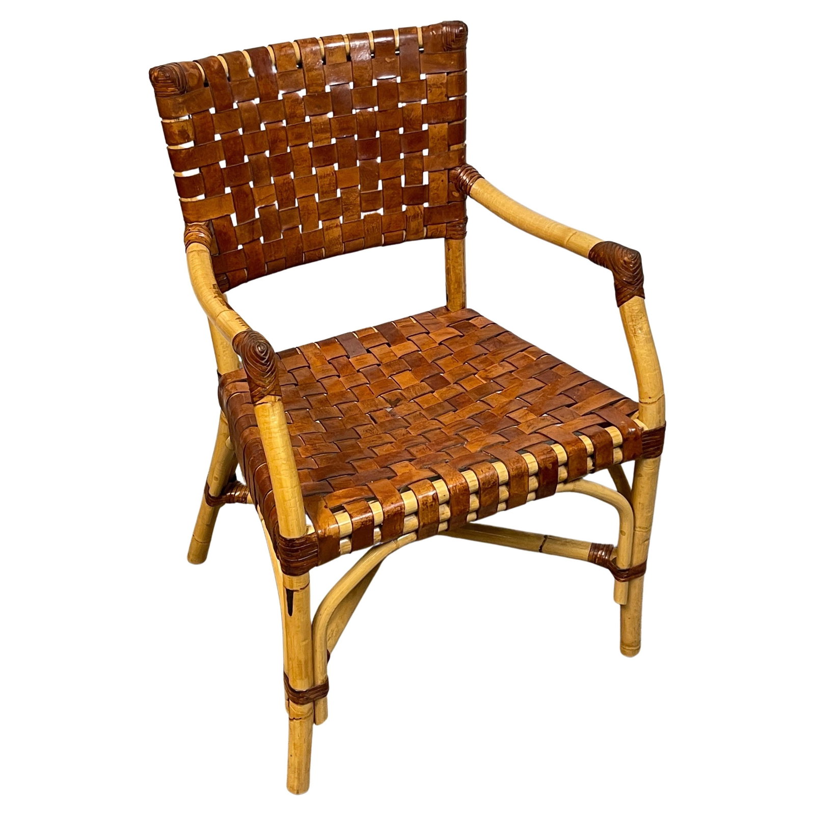 Vintage French Bamboo Saddle Leather Armchair 1960s Modern Design: Vintage French Bamboo Saddle Leather Armchair 1960s Modern Design Introducing a stunning French Modern Bamboo and Woven Saddle Leather Armchair from the 1960s. This exquisite piece showcases a harmoni