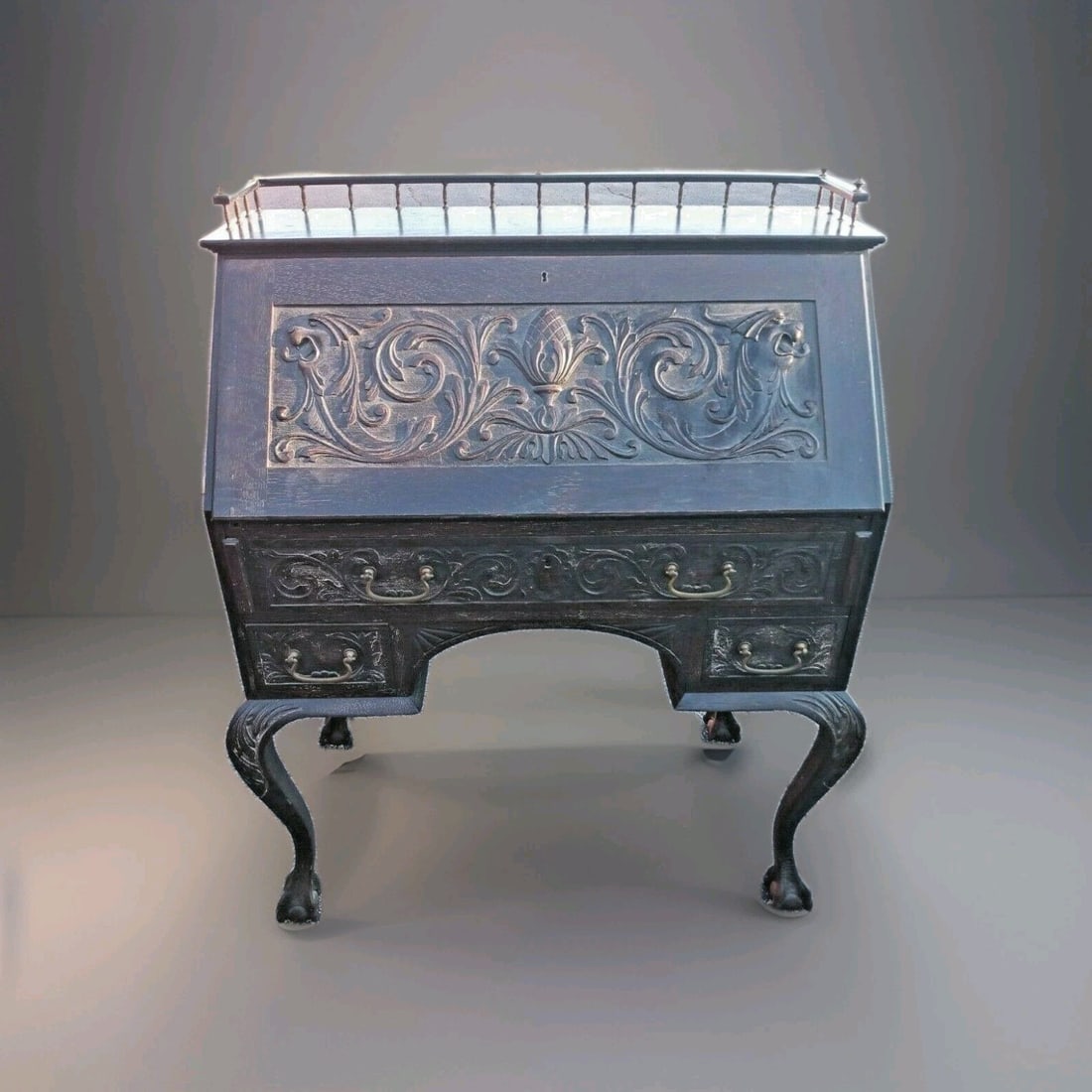 R J Horner carved oak drop front desk with gargoyle motif: R J Horner carved oak drop front desk with gargoyle motif Antique carved oak desk in a Gothic and American Spanish Revival style with dragon or gargoyle motifs. This drop-front desk features a fitted 