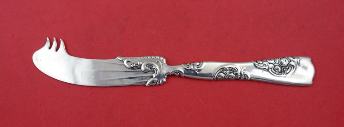 Whiting Rose and Scroll Sterling Silver Cheese Knife with Pick 7.5": Whiting Rose and Scroll Sterling Silver Cheese Knife with Pick 7.5" This exquisite Cheese Knife from the Rose and Scroll pattern by Whiting is crafted from sterling silver, showcasing a classic design