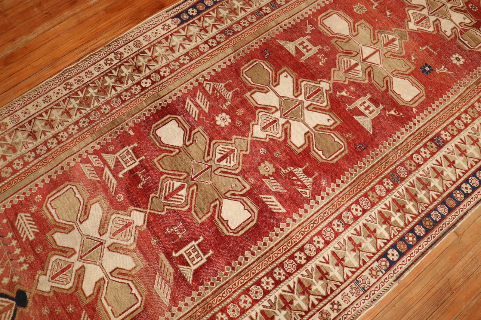 4' 10" x 10' 9" Caucasian Shirvan Gallery Rug: 4' 10" x 10' 9" Caucasian Shirvan Gallery Rug Early 20th century Rustic Caucasian Shirvan gallery rug with a red field and geometric design. This pre-owned rug reflects the traditional Shirvan style a
