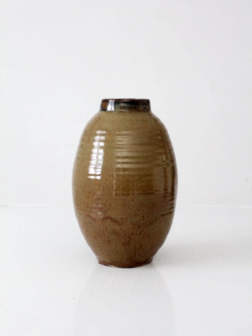 Ceramic Studio Pottery Vase with Ribbed Earth Tone Glaze 9.75 inch: Ceramic Studio Pottery Vase with Ribbed Earth Tone Glaze 9.75 inch This vintage handmade studio pottery vase showcases a rounded form with softly ribbed detailing and a glossy earth tone glaze in tan,