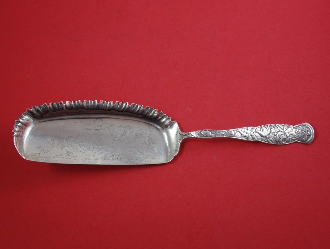 Knowles Sterling Silver Crumber Rose aka Bug Cherubs 11 3/4": Knowles Sterling Silver Crumber Rose aka Bug Cherubs 11 3/4" This exquisite crumber, known as "Rose aka Bug," is crafted from sterling silver by the renowned maker Knowles. Dating back to the late 19t