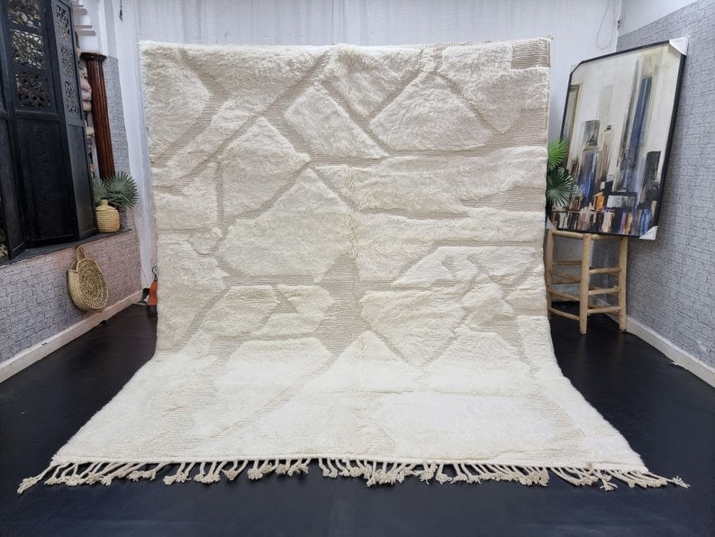 Authentic Handwoven Moroccan Berber Wool Rug 9.84 x 6.56 Feet: Authentic Handwoven Moroccan Berber Wool Rug 9.84 x 6.56 Feet Experience the beauty of Moroccan craftsmanship with this stunning authentic white soft engraved handwoven Berber wool rug. Crafted by loc