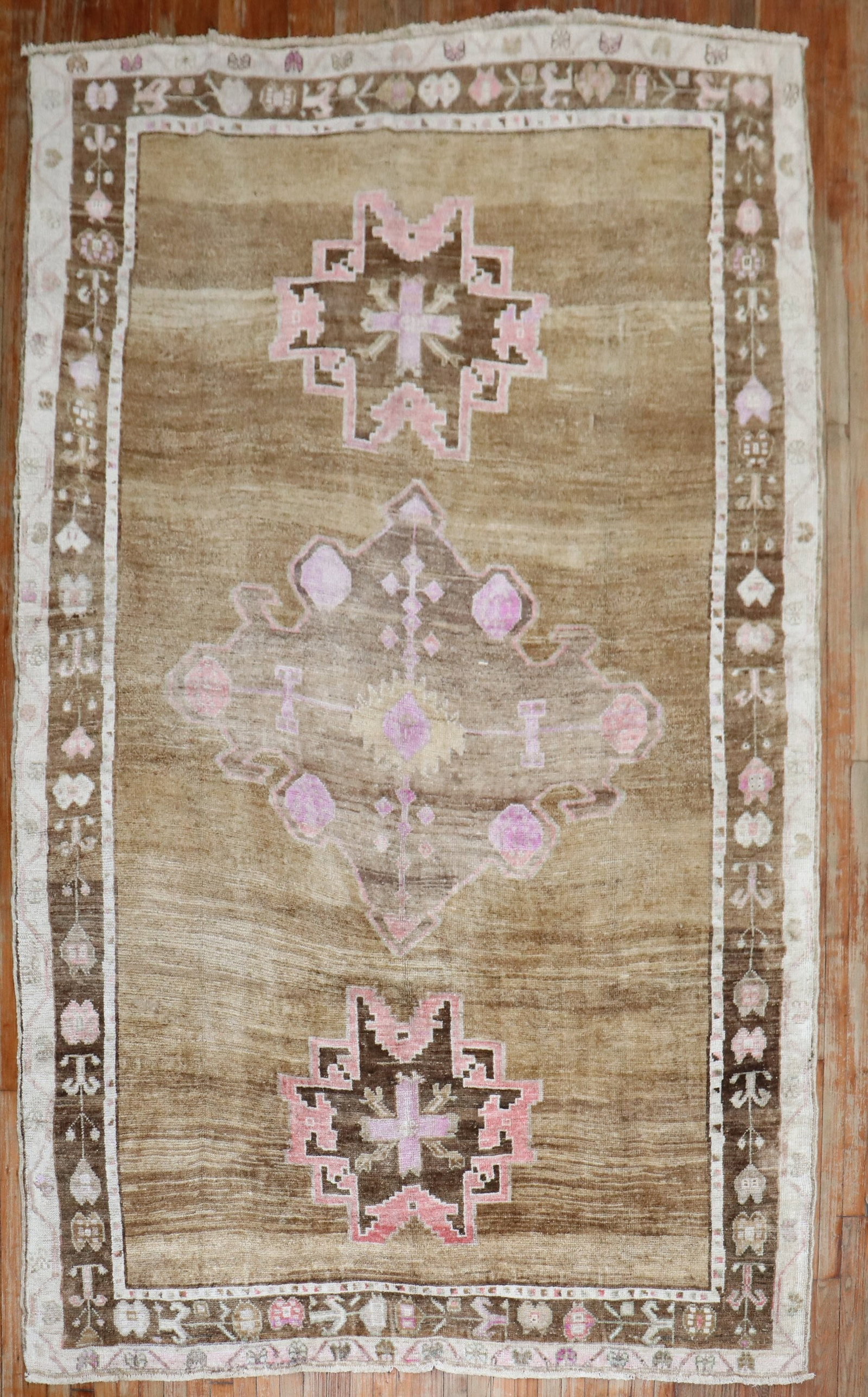 6' 6" x 9' 11" Mid 20th Century Turkish Kars Rug: 6' 6" x 9' 11" Mid 20th Century Turkish Kars Rug Mid-20th century Turkish Kars rug with a primitive design and a brown, pink, and ivory color palette. This pre-owned piece is identified as an intermed