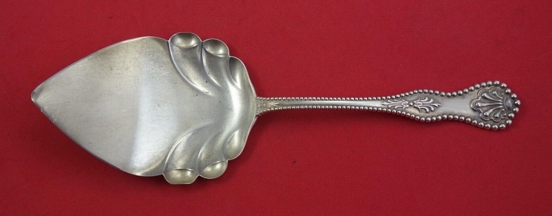 Dominick and Haff Charles II Sterling Silver Pie Server 9 3/4": Dominick and Haff Charles II Sterling Silver Pie Server 9 3/4" Sterling silver pie server in the Charles II pattern by Dominick & Haff. It features a flat handle and an ornate serving end, and is not 