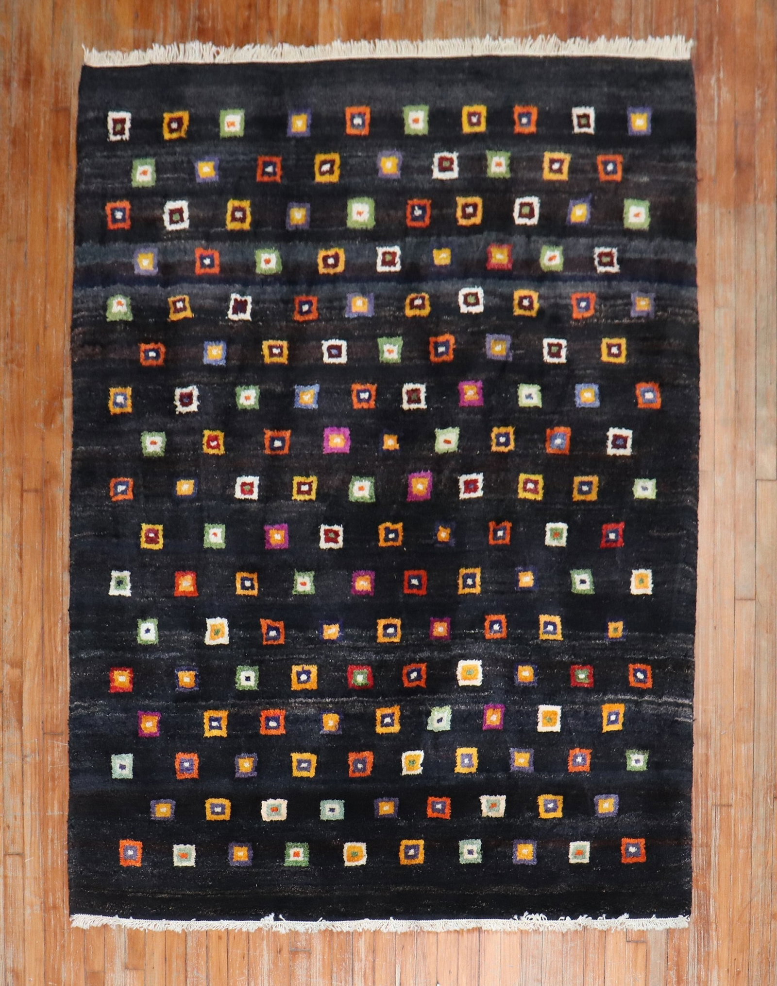 5' 8" x 7' 6" Turkish wool rug black ground box pattern: 5' 8" x 7' 6" Turkish wool rug black ground box pattern One-of-a-kind Turkish contemporary wool rug featuring a colorful all-over box square pattern on a black ground. This pre-owned piece is describe