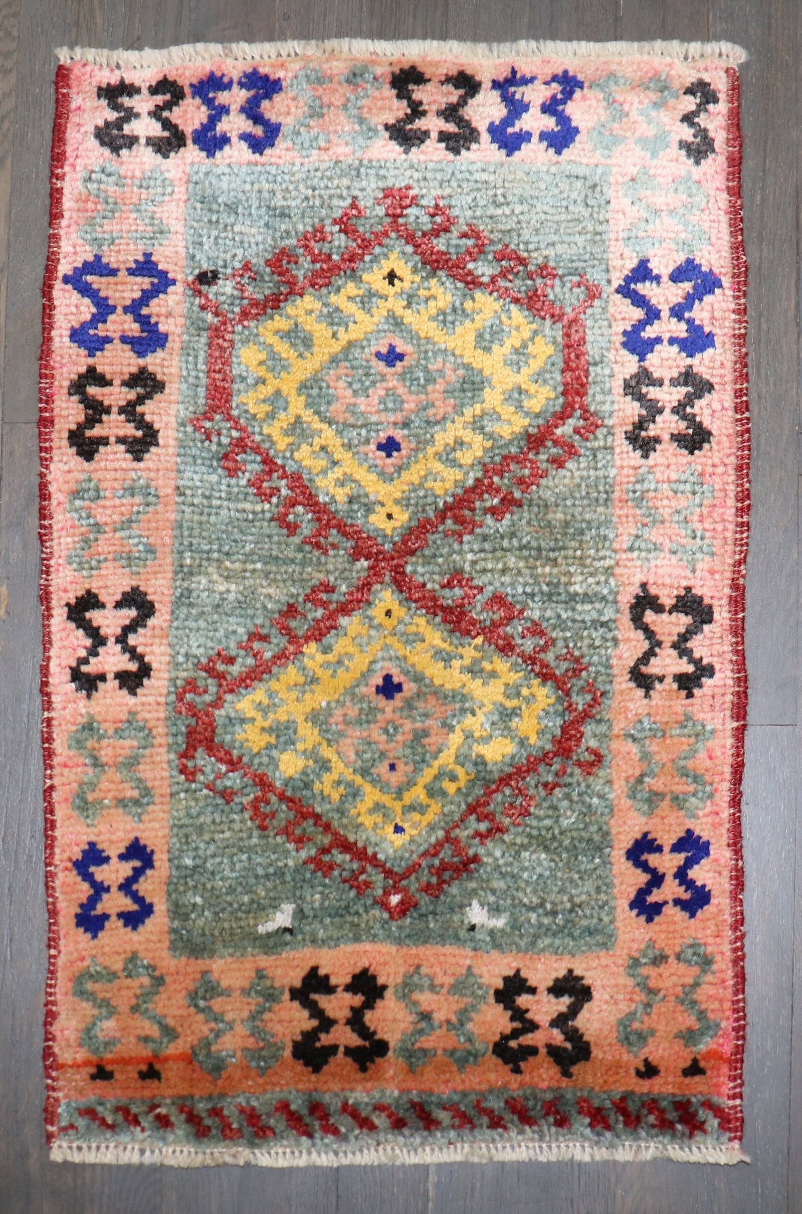 1' 6" x 2' 4" Geometric Anatolian Yastik Rug: 1' 6" x 2' 4" Geometric Anatolian Yastik Rug Mid-20th-century Anatolian mini-size rug featuring a geometric, colorful design. This pre-owned piece is categorized as a square yastik. Specifications Ite