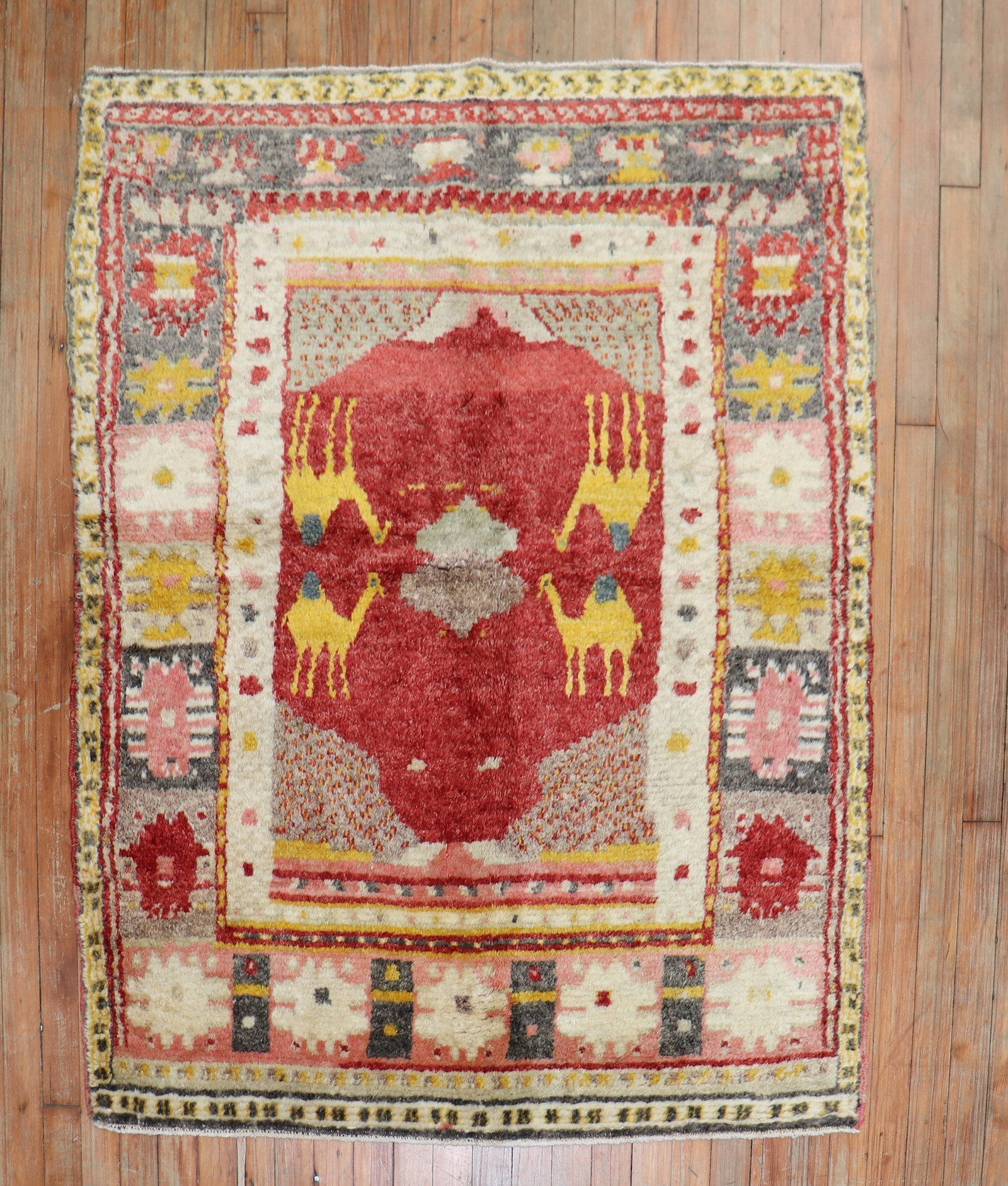 3' 9" x 4' 7" Konya pictorial Turkish rug with 4 camels: 3' 9" x 4' 7" Konya pictorial Turkish rug with 4 camels Hand-knotted Turkish village rug in a scatter size format, featuring four gold camels on a bright red field. This mid-20th-century pictorial Kon