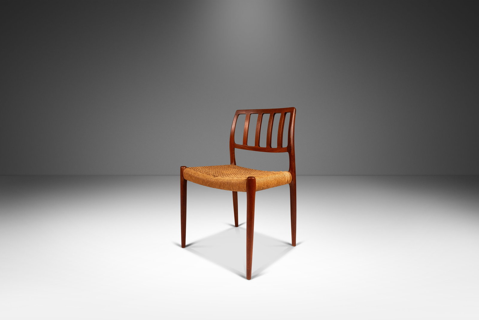 Rare Niels Otto Moller Model 83 Teak Dining Chair with Paper Cord Seat: Rare Niels Otto Moller Model 83 Teak Dining Chair with Paper Cord Seat Introducing a rare Niels Otto Moller Model 83 side chair for J.L. Moller Mobelfabrik, crafted in the 1960s in Denmark. This stunn