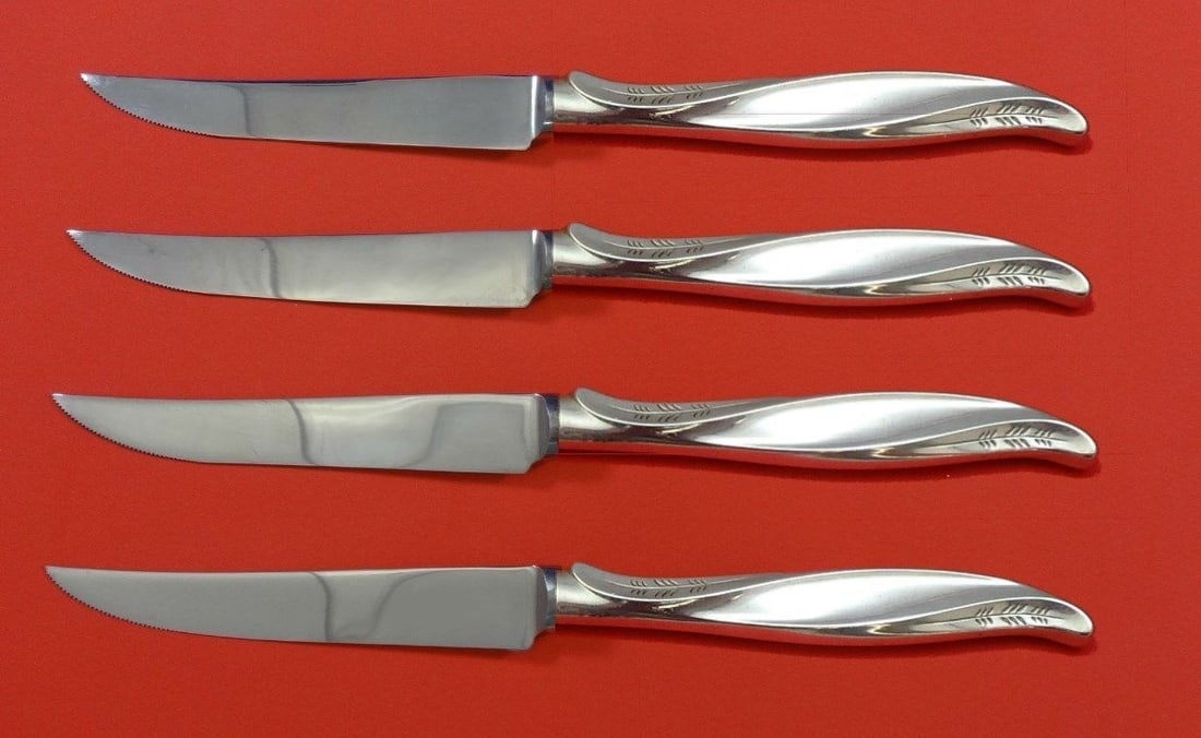 International Sterling Silver Pine Spray Steak Knife Set 4pc: International Sterling Silver Pine Spray Steak Knife Set 4pc This exquisite 4-piece steak knife set features the elegant Pine Spray pattern by International Sterling Silver. Each knife is crafted with
