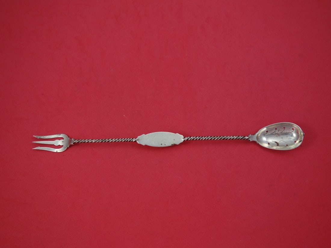 Twisted Pierced Coin Silver Pickle Fork Olive Spoon 10 3/4 in: Twisted Pierced Coin Silver Pickle Fork Olive Spoon 10 3/4 in A coin silver serving piece by various makers, described as a pickle fork and olive spoon combination with a twisted, pierced design. It i