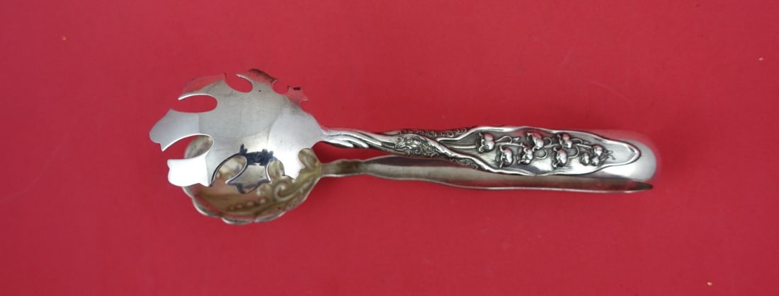 Whiting Sterling Silver Ice Tong Lily of the Valley 6 1/2" Serving Piece: Whiting Sterling Silver Ice Tong Lily of the Valley 6 1/2" Serving Piece This exquisite ice tong from Whiting showcases the elegant Lily of the Valley pattern, crafted from high-quality sterling silve