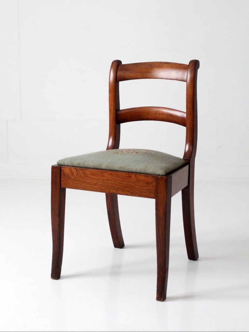 Early 20th Century French Ladder Back Chair With Floral Needlepoint Seat: Early 20th Century French Ladder Back Chair With Floral Needlepoint Seat This early 20th century French country ladder-back chair features a composed silhouette with curved slats and subtly shaped leg