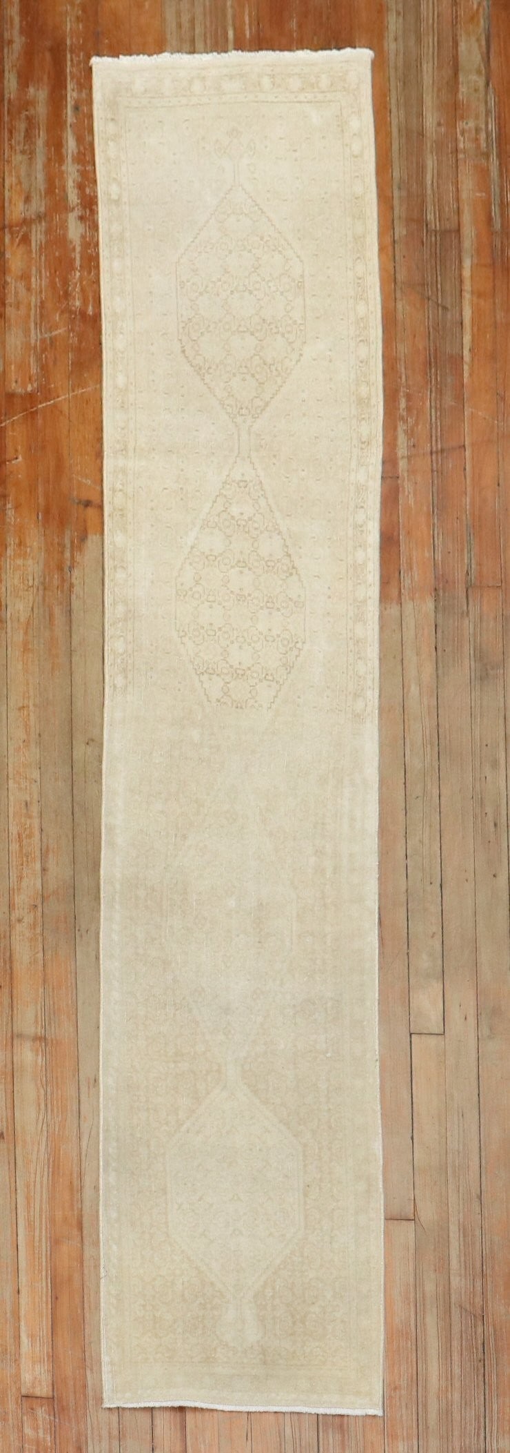 1' 7" x 7' 8" Persian Tabriz rug runner pale: 1' 7" x 7' 8" Persian Tabriz rug runner pale A pale, narrow Persian Tabriz runner from the mid-20th century. This pre-owned rug features the classic runner format and is identified as a Tabriz piece. 