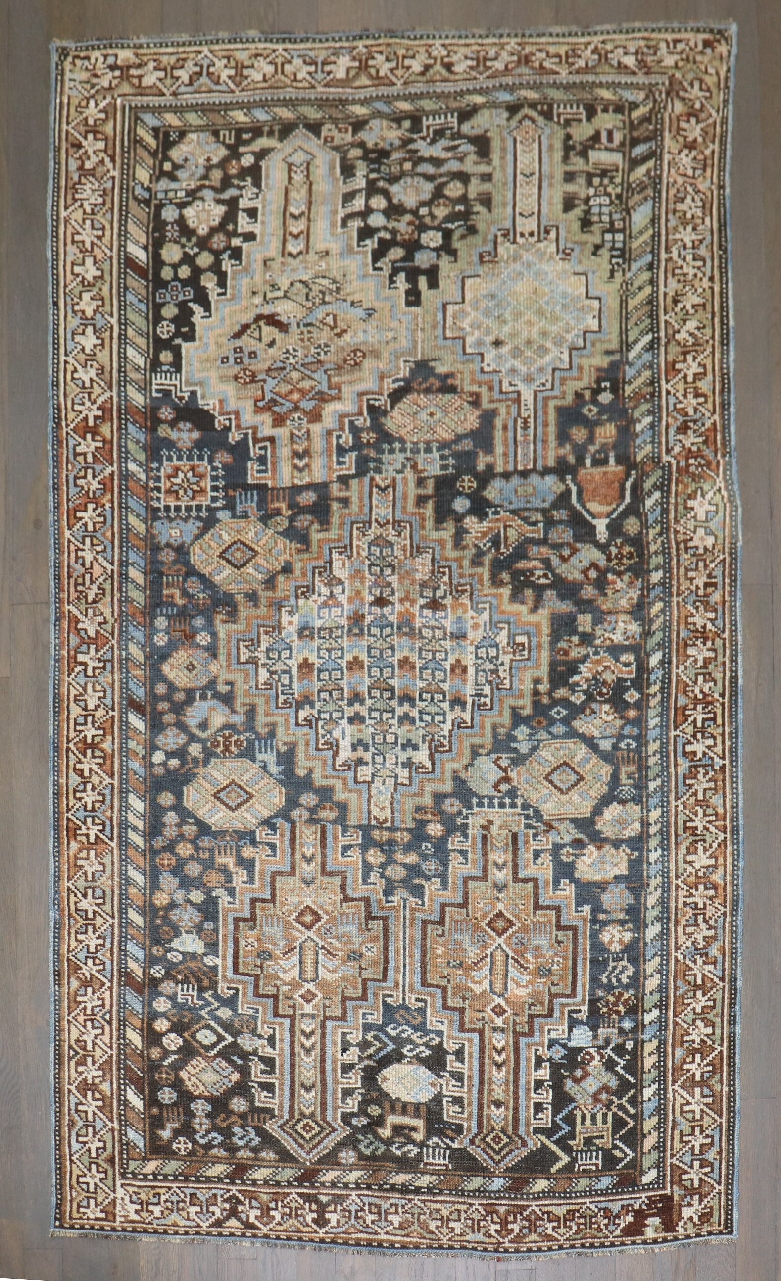 3' 3" x 5' 6" Persian Shiraz Tribal Geometric Rug: 3' 3" x 5' 6" Persian Shiraz Tribal Geometric Rug A pre-owned 1920s Persian Shiraz geometric tribal rug with a classic tribal design in a small-format size. Specifications Type: Shiraz Origin: Persian