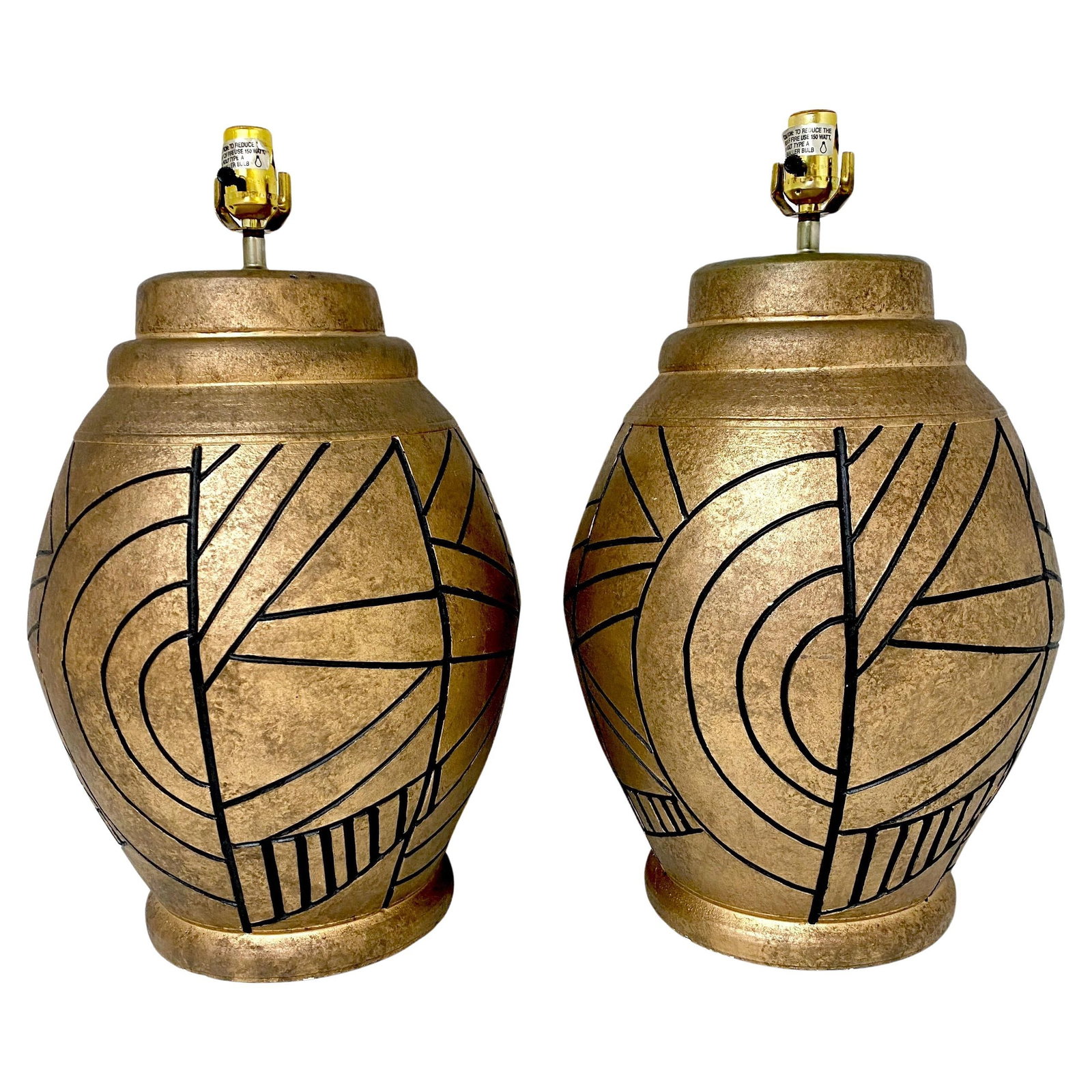 Large California Studios Abstract Engraved Lamps Set of 2 1985: Large California Studios Abstract Engraved Lamps Set of 2 1985 This large pair of California Studios lamps showcases a striking earth tone and abstract design, perfect for enhancing any modern space. 