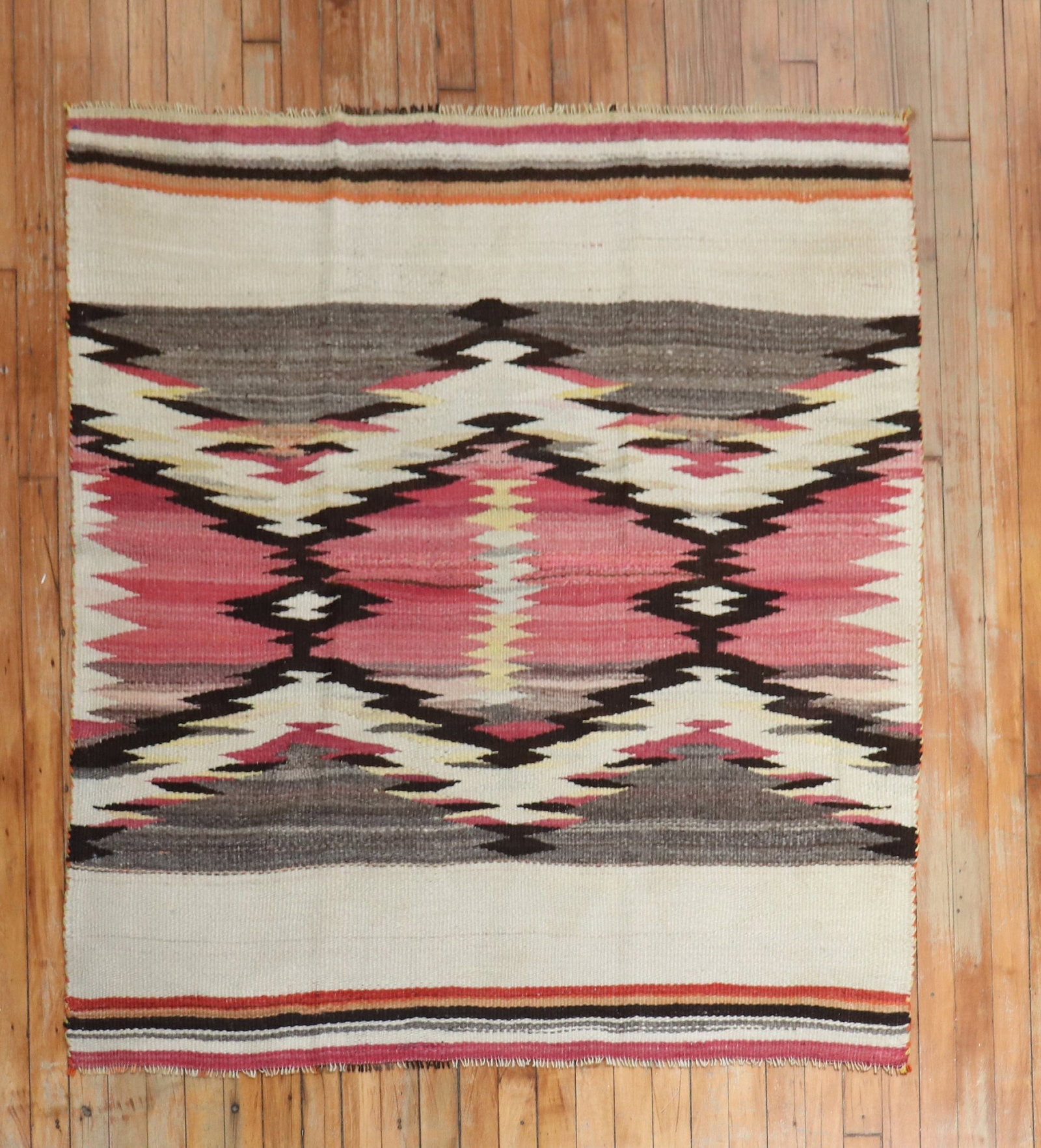 4' 2" x 4' 8" American Navajo Accent Rug: 4' 2" x 4' 8" American Navajo Accent Rug Early 20th century American Navajo accent rug with a decorative woven design. This pre-owned square rug is identified as Navajo and offers a distinctive geomet