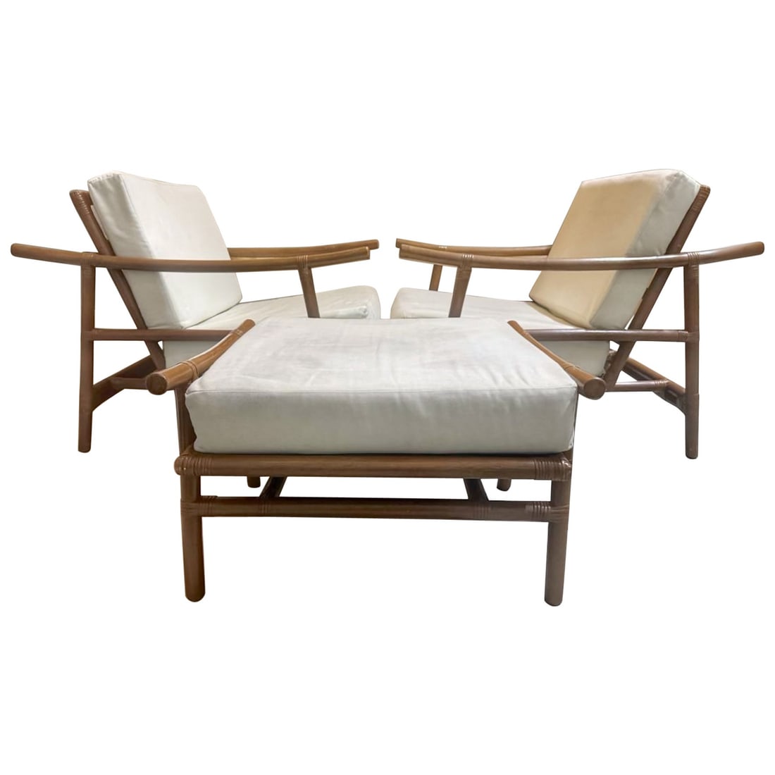 Ficks Reed 1960s Rattan Club Chairs and Ottoman Set: Ficks Reed 1960s Rattan Club Chairs and Ottoman Set This exquisite set features a pair of dark natural rattan club chairs and a matching ottoman, designed by John Wisner in the 1960s. The unique desig