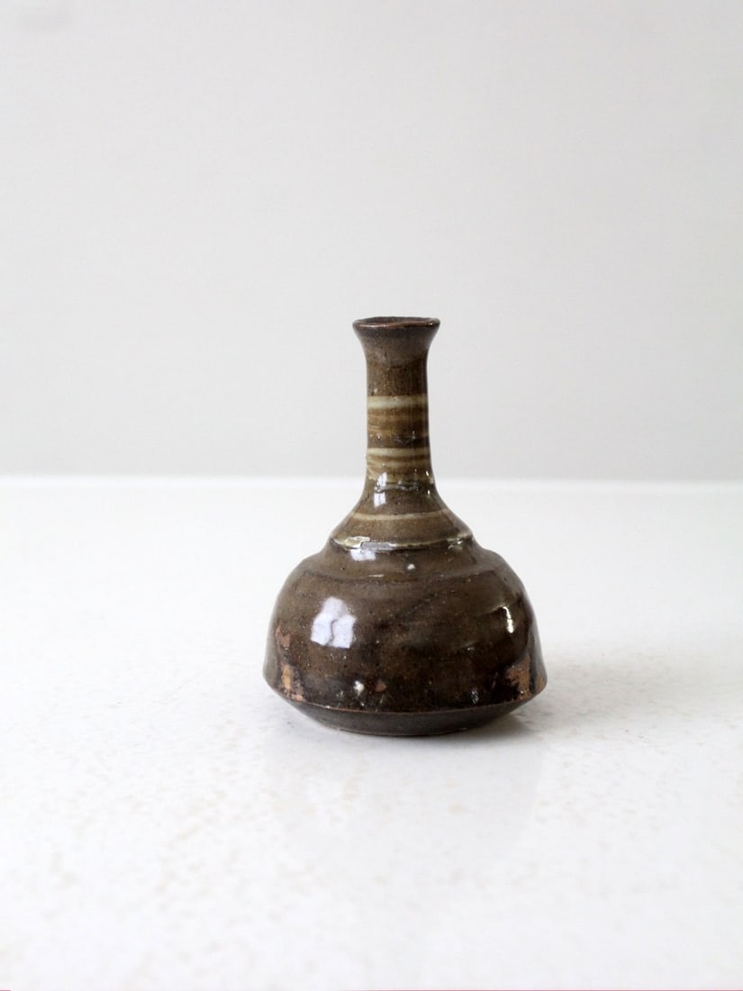 Handmade Olive Brown Glazed Vase with Long Neck 5.25 Inch: Handmade Olive Brown Glazed Vase with Long Neck 5.25 Inch This vintage studio pottery vase features a handmade design with a long bottleneck and a warm olive brown glaze. It is in good condition, show