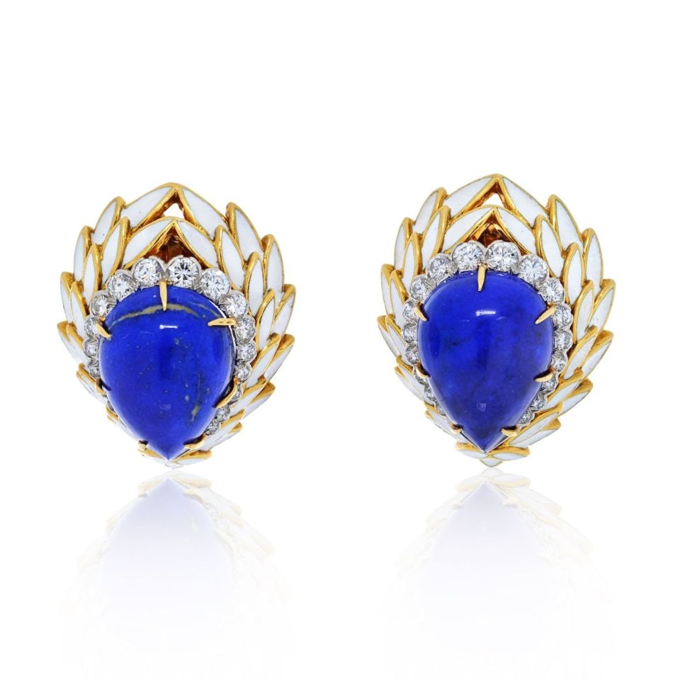 David Webb Lapis Diamond Enamel Clip Earrings in Platinum and 18K Gold: David Webb Lapis Diamond Enamel Clip Earrings in Platinum and 18K Gold Vintage David Webb clip-on earrings featuring carved pear cut lapis lazuli cabochons framed by opaque white enamel lotus petals, 