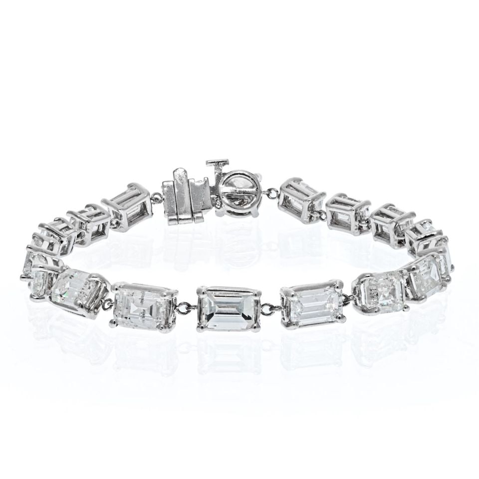 Platinum Diamond Tennis Bracelet 12.53 cttw Emerald Cut 7 Inches: Platinum Diamond Tennis Bracelet 12.53 cttw Emerald Cut 7 Inches Pre-owned platinum tennis bracelet set with a single line of 17 emerald cut diamonds. The diamonds have a total carat weight of 12.53 c