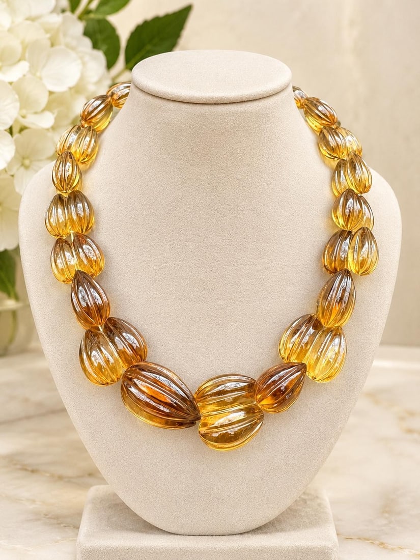 Lemon Quartz Beaded Necklace with 14k Yellow Gold Clasp: Lemon Quartz Beaded Necklace with 14k Yellow Gold Clasp Graduated beaded necklace featuring natural genuine lemon quartz carved in a grooved double acorn shape and finished with a 14k yellow gold clas