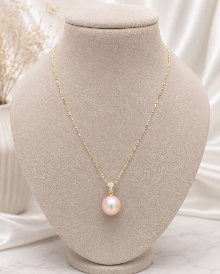 14k Yellow Gold Pearl Pendant Necklace with Diamond Bail 17 in: 14k Yellow Gold Pearl Pendant Necklace with Diamond Bail 17 in Elegant pendant chain necklace crafted in solid 14k yellow gold, featuring a round light golden pink cultured pearl accented by seven nat