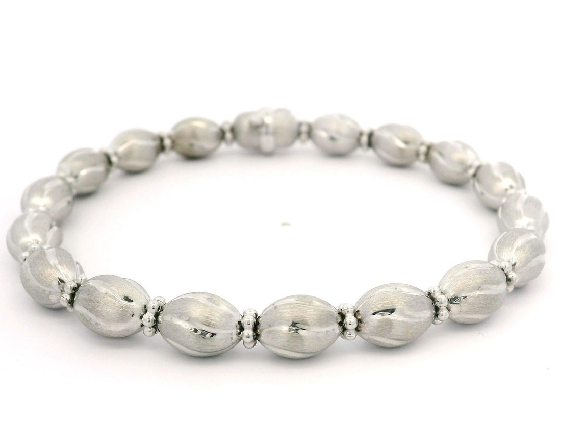 14k White Gold Oval Bead Link Bracelet 7 in Italian Brushed Finish: 14k White Gold Oval Bead Link Bracelet 7 in Italian Brushed Finish Italian-made bracelet crafted in solid 14k white gold with a brushed finish and polished cut oval bead links. This pre-owned piece fe