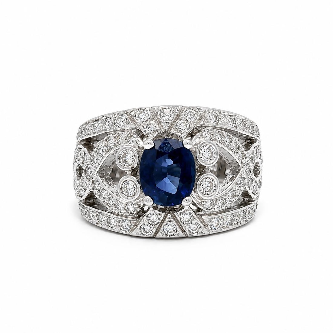 White Gold Cocktail Ring with 2.15ctw Sapphire and Diamonds: White Gold Cocktail Ring with 2.15ctw Sapphire and Diamonds Pre-owned cocktail ring featuring an oval natural blue sapphire accented by natural diamonds in a wide openwork cigar band design. Crafted i