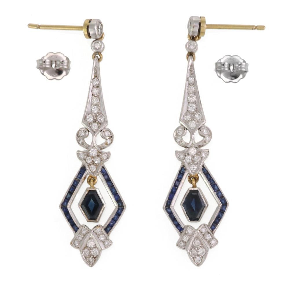 Vintage Platinum 18k Gold Sapphire Diamond Drop Earrings Pair: Vintage Platinum 18k Gold Sapphire Diamond Drop Earrings Pair This exquisite pair of vintage dangle earrings showcases a stunning combination of platinum and 18k yellow gold. The earrings feature a di